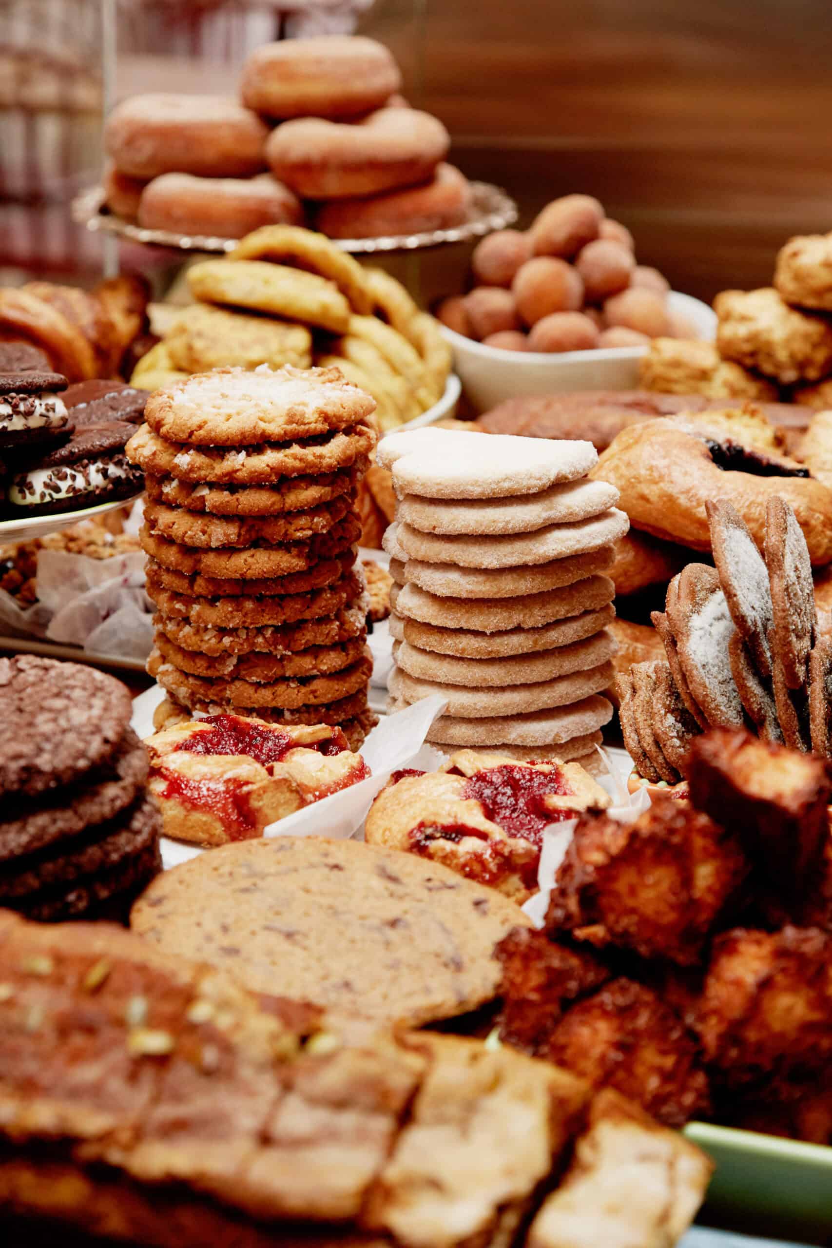 our pastry case filled with stacks of cookies, donuts, a variety of breads and pastries